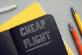 Business concept meaning CHEAP FLIGHT with sign on the piece of paper. Cheapflights is a travel fare metasearch engine