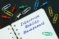Business concept meaning Enterprise Mobility Management EMM with inscription on the sheet