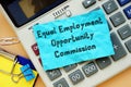 Business concept meaning Equal Employment Opportunity Commission EEOC with sign on the sheet