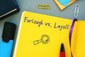 Business concept meaning Furlough vs Layoff with inscription on the sheet Royalty Free Stock Photo