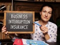 Business concept meaning BUSINESS INTERRUPTION INSURANCE with inscription on the board