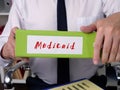 Business concept meaning Medicaid with sign on the page