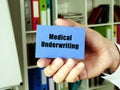 Business concept meaning Medical Underwriting with sign on the blue business card