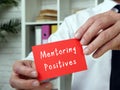 Business concept meaning Mentoring Positives with phrase on the sheet Royalty Free Stock Photo
