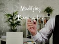 Business concept meaning Modifying Bankruptcy with sign on the sheet Royalty Free Stock Photo