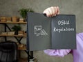 Business concept meaning OSHA Regulations with sign on the sheet