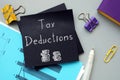 Business concept meaning Tax Deductions with inscription on the sheet