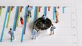 Business concept with miniature people standing on a graph. Royalty Free Stock Photo