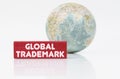 Near the globe is a red plaque with the inscription - Global Trademark
