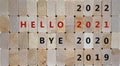 Business concept of 2021 new year. Wooden blocks with the words `bye 2020, hello 2021`. 2019, 2022 numbers. Beautiful wooden Royalty Free Stock Photo