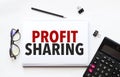 Business concept. Notebook with text profit sharing sheet of white paper for notes Royalty Free Stock Photo