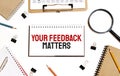 Business concept. Notebook with text YOUR FEEDBACK MATTERS sheet of white paper for notes, calculator, glasses, pencil, pen, in Royalty Free Stock Photo