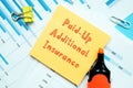 Business concept about Paid-Up Additional Insurance with inscription on the sheet