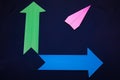 Business concept with paper plane and colored arrows on dark blue background Royalty Free Stock Photo