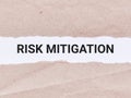 Business concept. Phrase risk mitigation written on paper strip.
