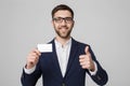 Business Concept - Portrait Handsome Business man showing name card with smiling confident face and thump up. White Royalty Free Stock Photo