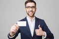 Business Concept - Portrait Handsome Business man showing name card with smiling confident face. White Background.Copy Royalty Free Stock Photo