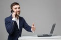 Business Concept - Portrait Handsome Business man showing thumb up and smiling confident face in front of his laptop Royalty Free Stock Photo