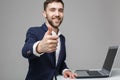 Business Concept - Portrait Handsome Business man showing thump up and smiling confident face in front of his laptop. White Backgr Royalty Free Stock Photo