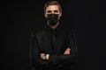 Business Concept - Portrait Handsome Businessman in protective face mask on black background Royalty Free Stock Photo