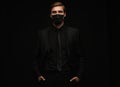 Business Concept - Portrait Handsome Businessman in protective face mask on black background