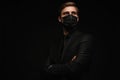 Business Concept - Portrait Handsome Businessman in protective face mask on black background