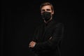 Business Concept - Portrait Handsome Businessman in protective face mask on black background Royalty Free Stock Photo