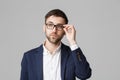 Business Concept - Portrait of a handsome businessman in suit with glasses serious thinking with stressful facial expression. Isol Royalty Free Stock Photo