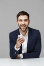 Business Concept - Portrait handsome happy handsome business man in suit playing moblie phone and smiling with laptop at work offi Royalty Free Stock Photo