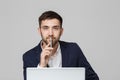 Business Concept - Portrait handsome happy handsome business man in suit playing moblie phone and smiling with laptop at work offi Royalty Free Stock Photo