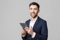 Business Concept - Portrait Handsome Business man playing digital tablet with smiling confident face. White Background Royalty Free Stock Photo