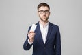 Business Concept - Portrait Handsome Business man showing name card with smiling confident face. White Background.Copy Space. Royalty Free Stock Photo