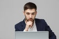 Business Concept - Portrait handsome stressful business man in suit shock looking at work in laptop. White Background.