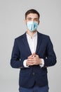 Business Concept - portrait young successful businessman in face mask osing over dark background. Copy space.