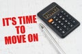 On the puzzles lies a calculator and a pen, next to the inscription - It is Time to Move On Royalty Free Stock Photo