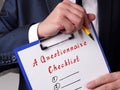 Business concept about A Questionnaire Checklist with sign on the piece of paper