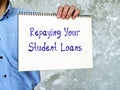 Business concept about Repaying Your Student Loans with inscription on the page