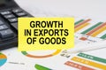 On business reports there is a calculator and a sign with the inscription - growth in exports of goods