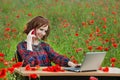 Business concept shot of a beautiful young woman sitting at a desk using a computer in a field. Royalty Free Stock Photo