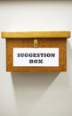 Business Concept Shot Of Wooden Suggestion Box On Wall In Office