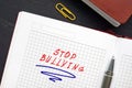 Business concept about STOP BULLYING with phrase on the piece of paper. Bullying is the use of force, coercion, hurtful teasing or