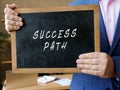 Business concept about SUCCESS PATH with sign on the blackboard