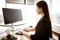 Business concept. Successful young businesswoman at work. Manager sitting at the office table and working on computer Royalty Free Stock Photo