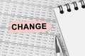 On the table among the reports is a notebook, a pen with an arrow with the inscription - CHANGE Royalty Free Stock Photo