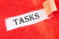 Business concept. TASKS - word on a white background under torn paper Royalty Free Stock Photo