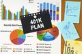 There are business charts, sticky notes and black paper with the inscription on the board - 401K PLAN