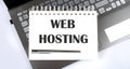 Business concept - Top view notebook writing Web Hosting on the laptop Royalty Free Stock Photo