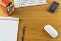 Top view office desk with mouse, laptop, Mobile phone, keyboard, bill book and pencil on wood table . With copy space for text or Royalty Free Stock Photo