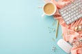 Top view photo of keyboard computer mouse cup of fresh coffee golden stationery pen clips adhesive tape flowers pink scarf Royalty Free Stock Photo