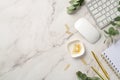 Business concept. Top view photo of workstation keyboard computer mouse gold pen notepad clips and eucalyptus on white marble Royalty Free Stock Photo